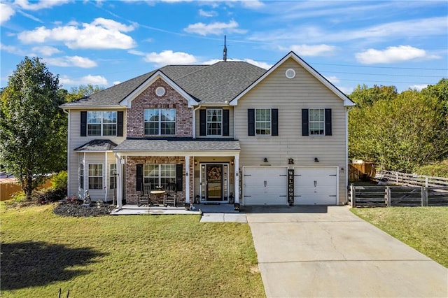 view of front of house featuring a front yard and a garage