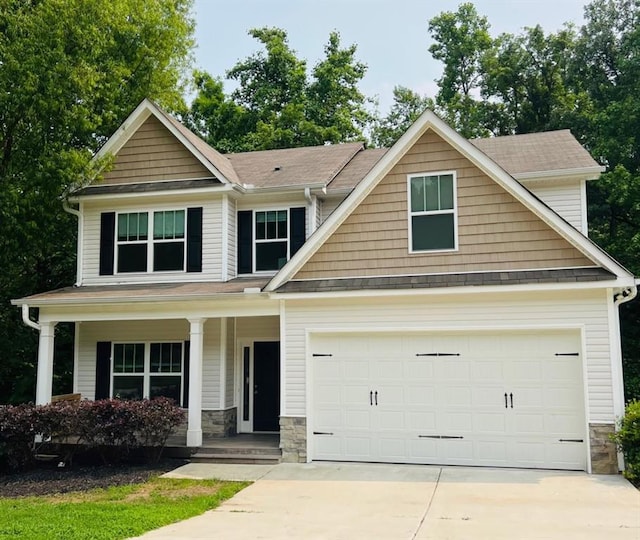 377 Fieldcrest Dr, Dallas, GA 30132 - craftsman house with stone siding, driveway, an attached garage, and covered porch