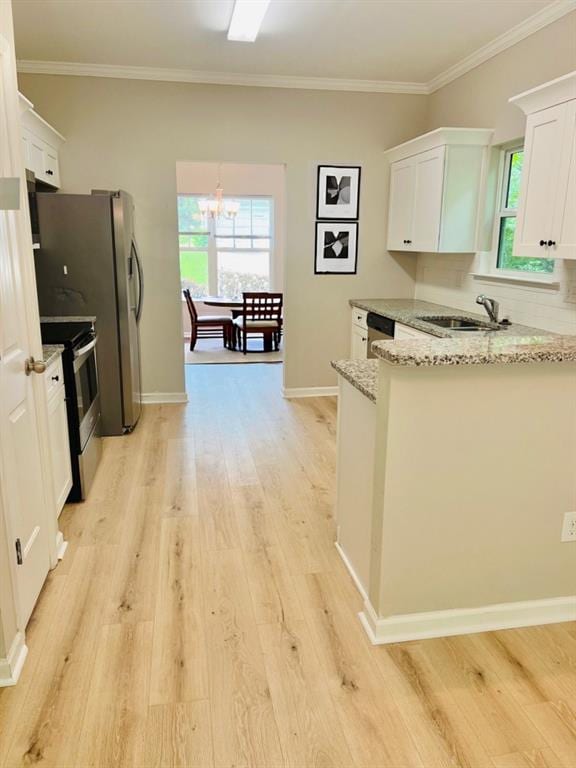 377 Fieldcrest Dr, Dallas, GA 30132 - kitchen featuring appliances with stainless steel finishes, a sink, light stone counters, light wood-type flooring, and a chandelier