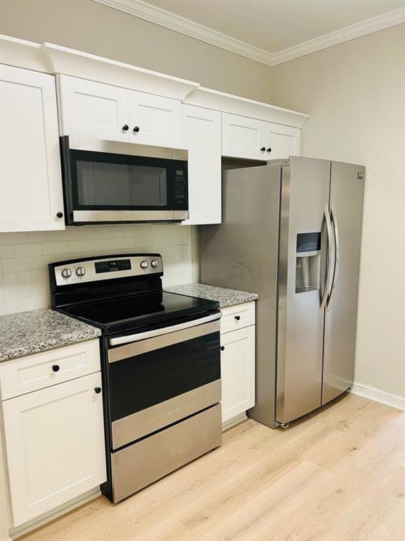 377 Fieldcrest Dr, Dallas, GA 30132 - kitchen with stainless steel appliances, light wood-type flooring, white cabinets, tasteful backsplash, and ornamental molding