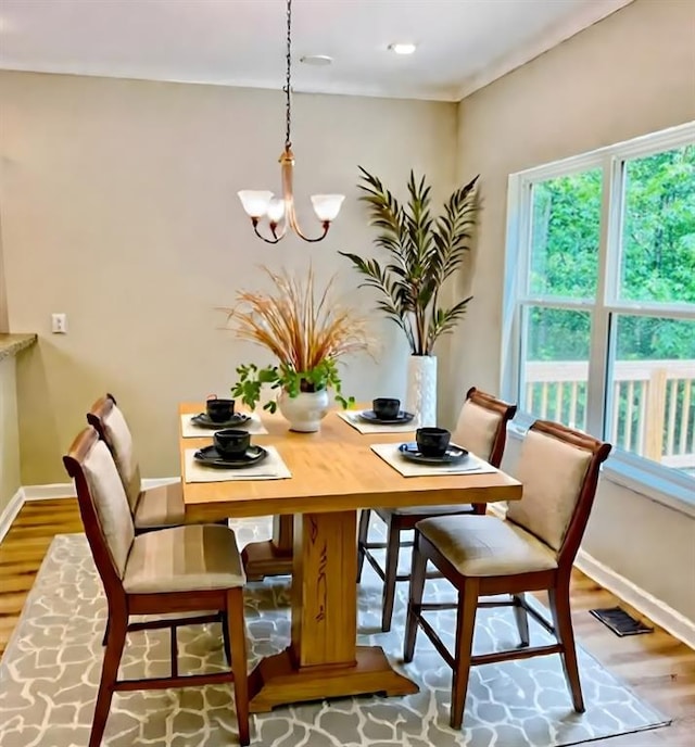 377 Fieldcrest Dr, Dallas, GA 30132 - dining room featuring a chandelier, wood finished floors, healthy amount of natural light, and baseboards