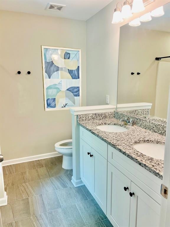 377 Fieldcrest Dr, Dallas, GA 30132 - full bathroom featuring toilet, double vanity, and baseboards