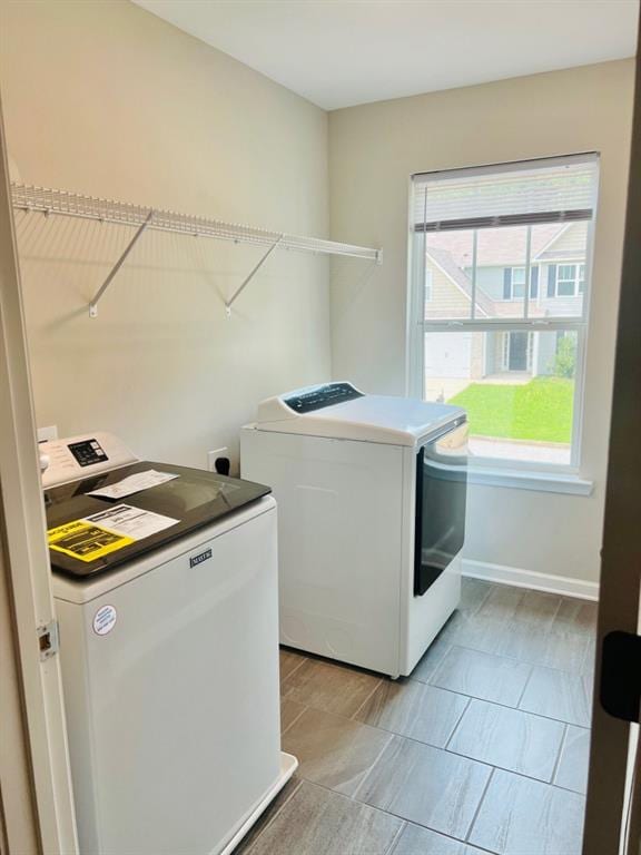 377 Fieldcrest Dr, Dallas, GA 30132 - washroom with washing machine and dryer, baseboards, and light tile patterned flooring