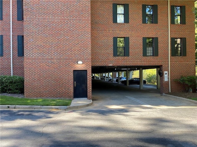 view of building exterior with a carport and driveway