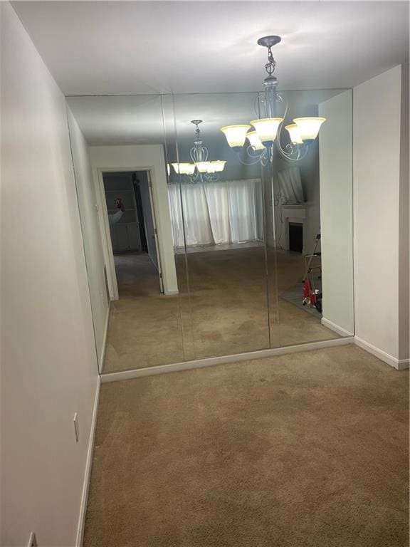 23210 Plantation Dr NE, Atlanta, GA 30324 - interior space with carpet flooring, baseboards, and an inviting chandelier