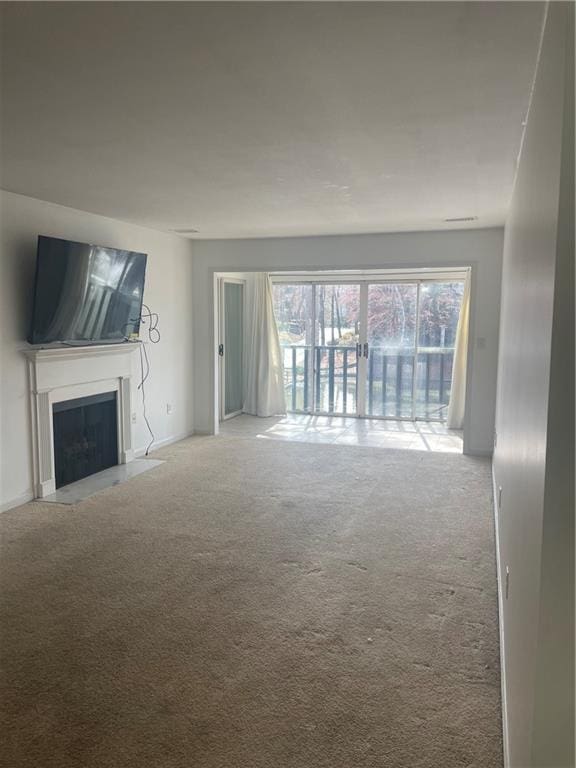 23210 Plantation Dr NE, Atlanta, GA 30324 - unfurnished living room with a fireplace with flush hearth and carpet flooring