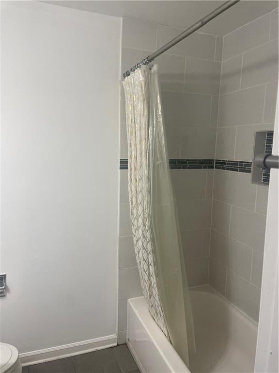 23210 Plantation Dr NE, Atlanta, GA 30324 - full bath with shower / tub combo, tile patterned flooring, baseboards, and toilet