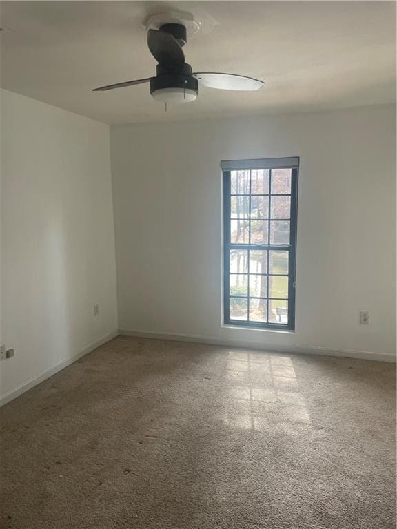 23210 Plantation Dr NE, Atlanta, GA 30324 - carpeted spare room with baseboards and a ceiling fan