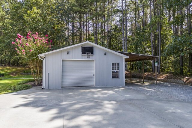 garage with a detached garage and concrete driveway