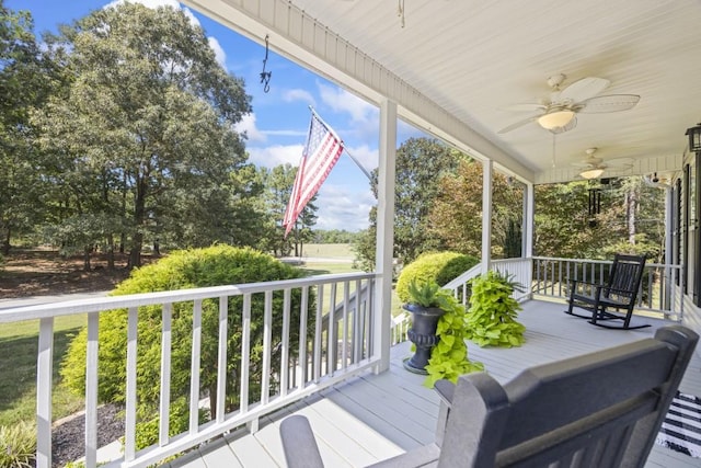 wooden terrace with a porch and ceiling fan