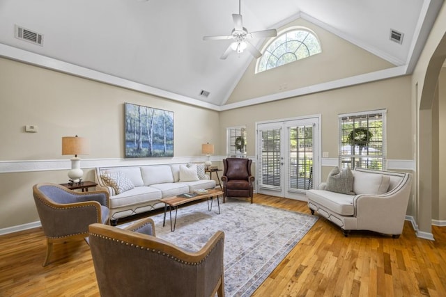 living room featuring high vaulted ceiling, ceiling fan, and light hardwood / wood-style flooring