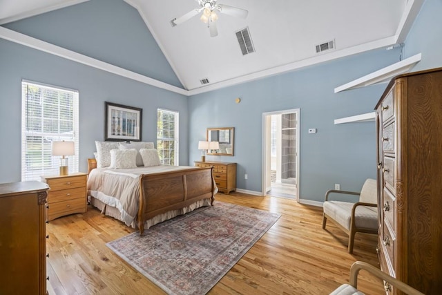 bedroom with high vaulted ceiling, ceiling fan, connected bathroom, and light hardwood / wood-style flooring