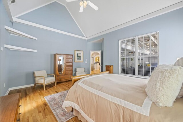bedroom featuring high vaulted ceiling, wood finished floors, baseboards, visible vents, and ceiling fan