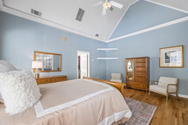 bedroom featuring high vaulted ceiling, light hardwood / wood-style flooring, and ceiling fan