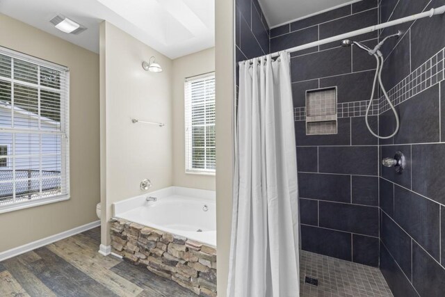 full bath featuring a stall shower, toilet, wood finished floors, a bath, and visible vents