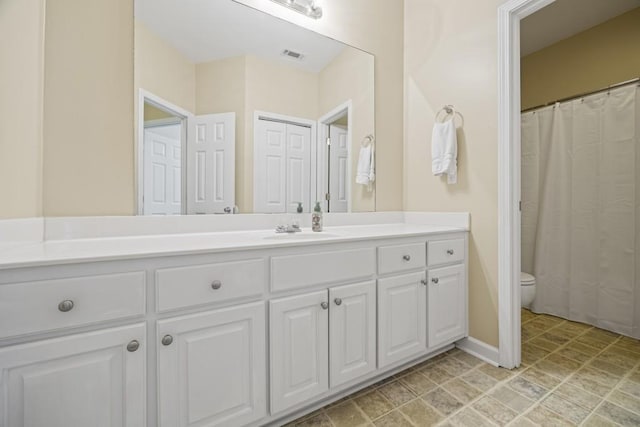 bathroom featuring toilet and vanity