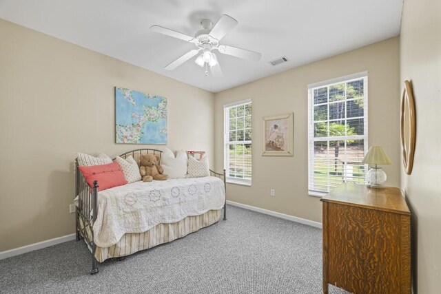 bedroom featuring baseboards, visible vents, carpet floors, and a ceiling fan