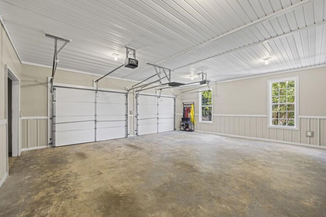garage with a wainscoted wall and a garage door opener