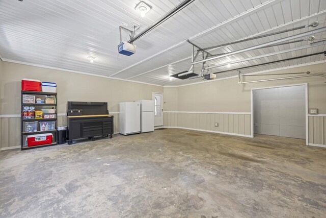 garage with a garage door opener and freestanding refrigerator