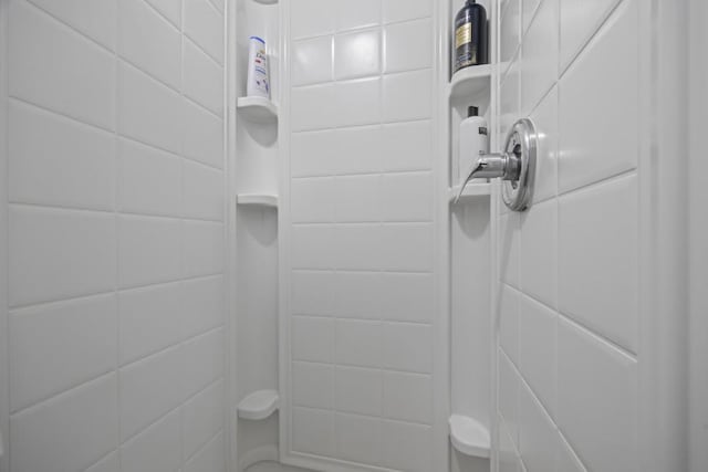 bathroom with a tile shower