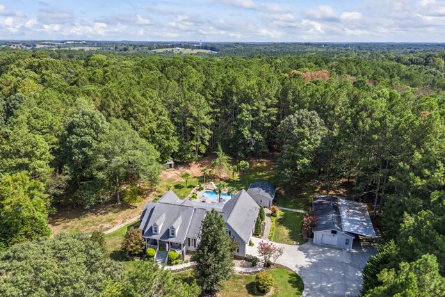 birds eye view of property with a wooded view