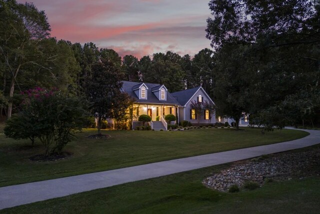 view of front of house with a porch and a lawn