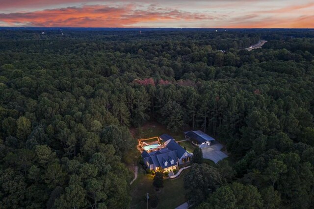 drone / aerial view featuring a forest view
