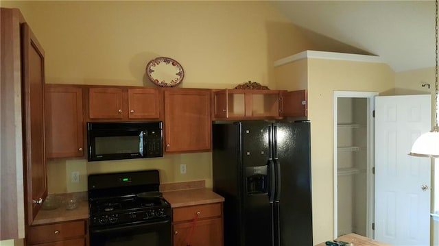 kitchen with lofted ceiling, black appliances, brown cabinetry, and light countertops