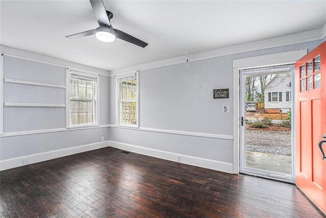 121 Norris St, Monroe, GA 30655 - unfurnished living room with baseboards, ornamental molding, a fireplace with raised hearth, and wood finished floors