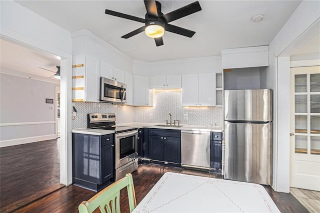 kitchen with open shelves, backsplash, appliances with stainless steel finishes, dark wood-type flooring, and a sink