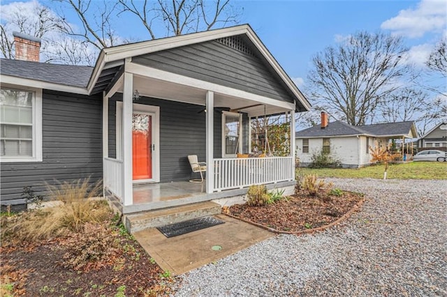 property entrance with a chimney and a porch