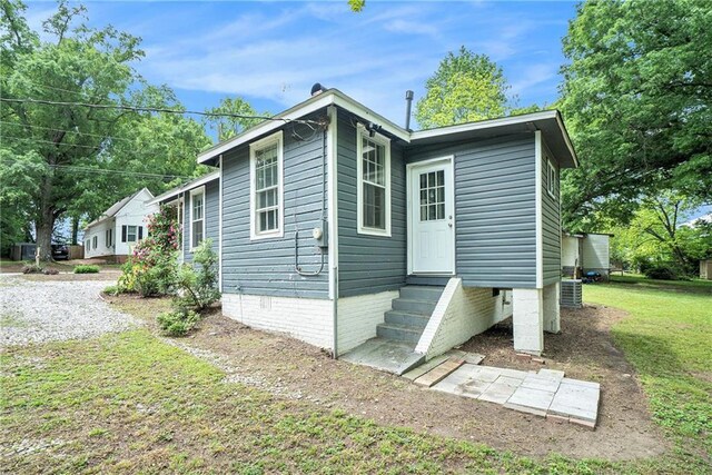 121 Norris St, Monroe, GA 30655 - rear view of property featuring central AC and a chimney