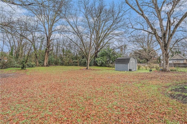 view of yard with a shed, fence, and an outdoor structure