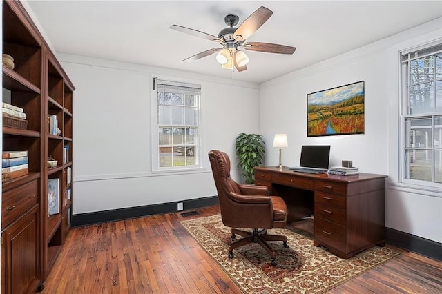 office with baseboards, ornamental molding, ceiling fan, and dark wood-type flooring