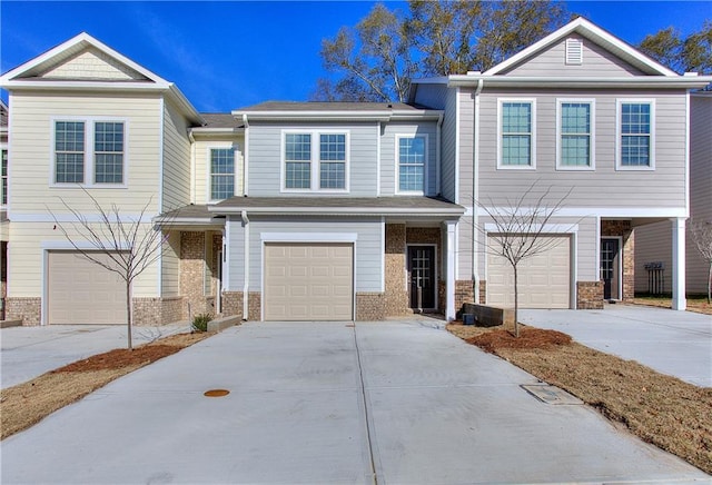 view of front of property featuring driveway, brick siding, and an attached garage