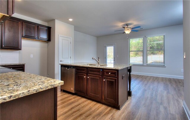 kitchen with a sink, light wood-type flooring, plenty of natural light, and dishwasher