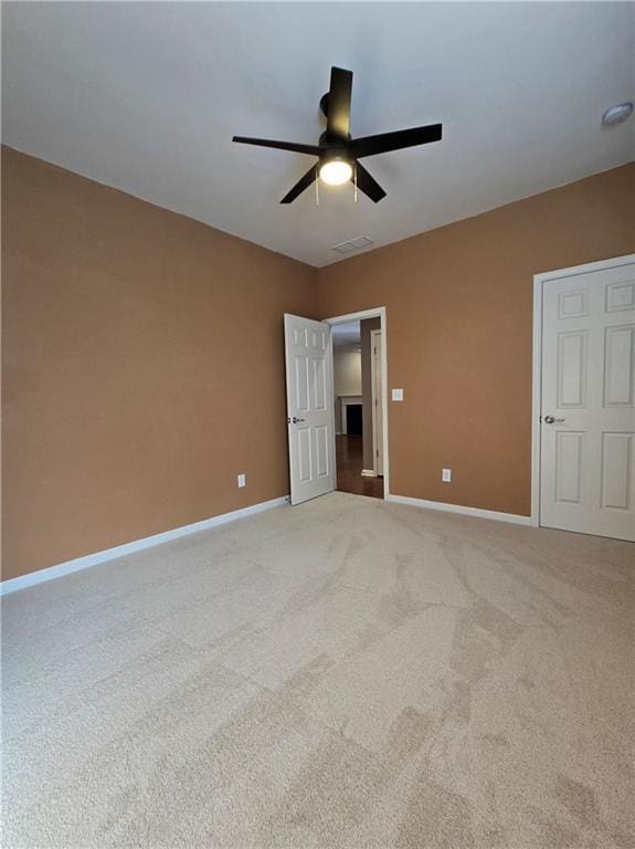 unfurnished bedroom featuring ceiling fan and light carpet