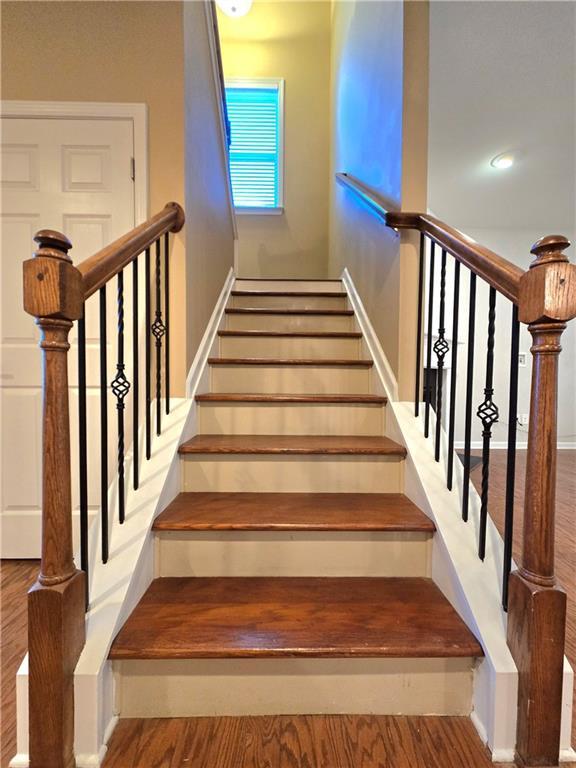 staircase featuring hardwood / wood-style flooring