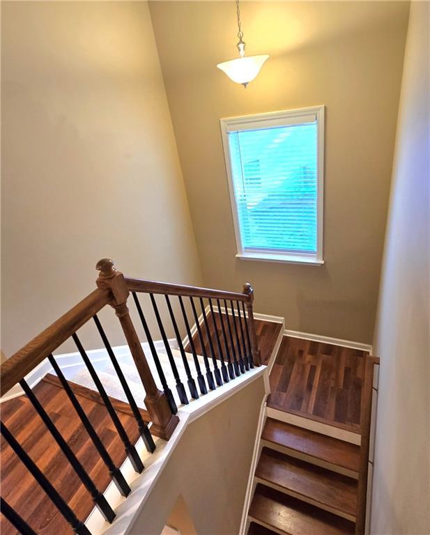 stairway featuring hardwood / wood-style flooring