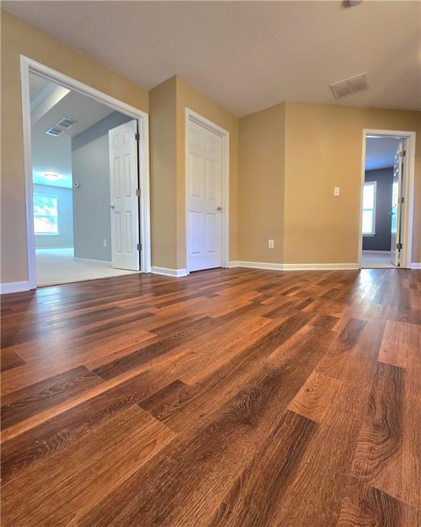 empty room with dark wood-type flooring