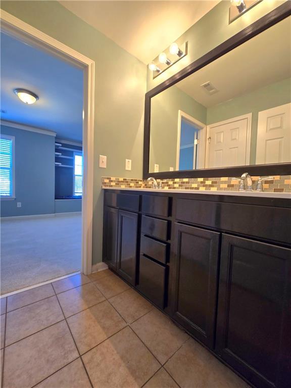 bathroom featuring tile patterned flooring and vanity