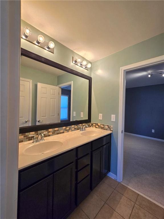 bathroom with tile patterned flooring, vanity, and backsplash