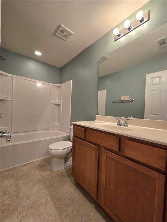 full bathroom featuring toilet, shower / bath combination, and vanity