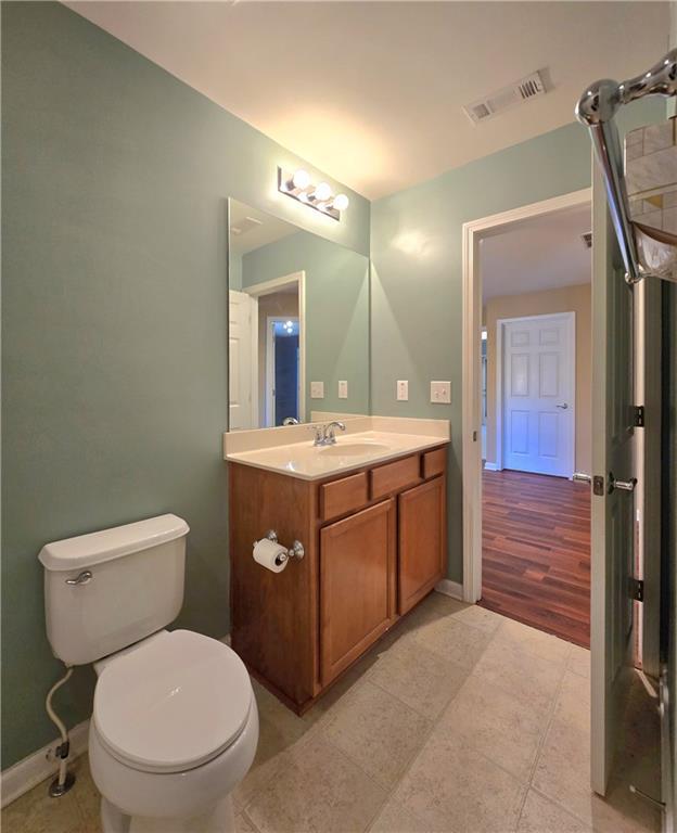 bathroom featuring tile patterned floors, toilet, and vanity