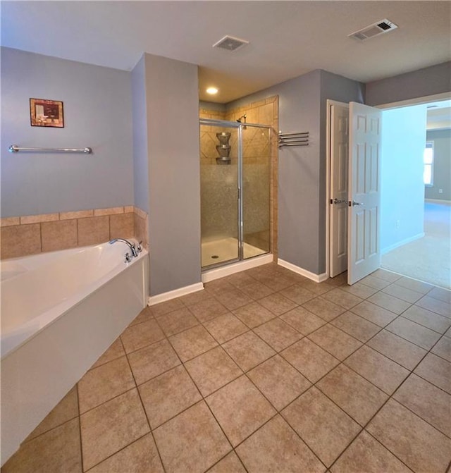 bathroom with tile patterned floors and shower with separate bathtub