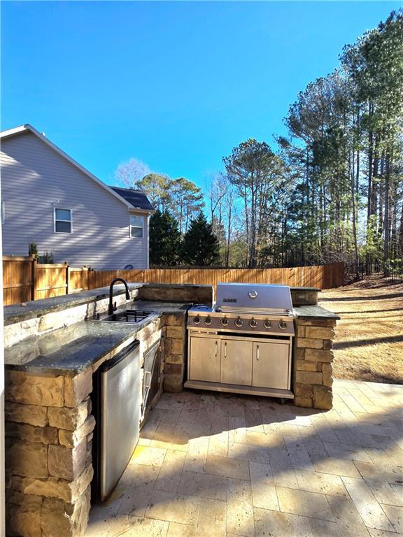 view of patio / terrace featuring grilling area, exterior kitchen, and sink