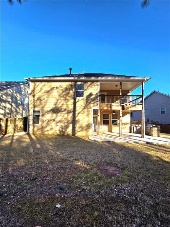 rear view of property with a balcony and a patio