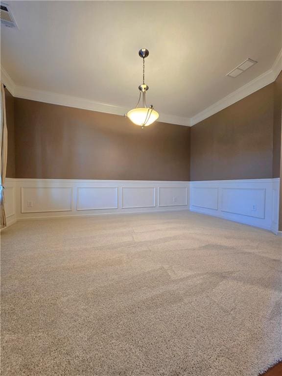 spare room featuring light colored carpet and ornamental molding