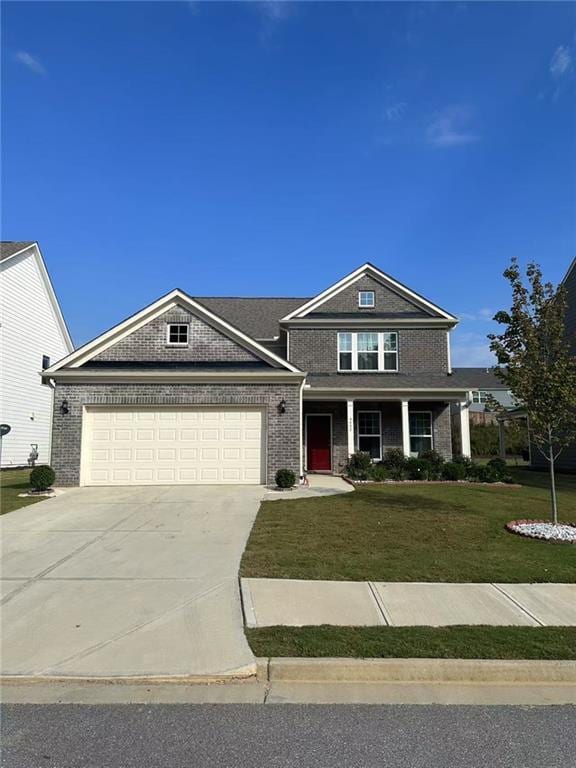 5452 Fountainhead Ln, Auburn, GA 30011 - view of front of property featuring a porch, driveway, a front yard, a garage, and brick siding