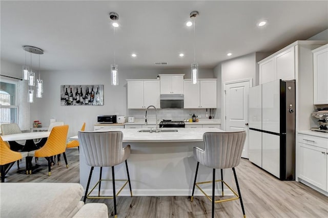 5452 Fountainhead Ln, Auburn, GA 30011 - kitchen with light wood-style floors, light countertops, and freestanding refrigerator